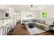 Bright living room features new flooring and neutral paint, with modern furniture adding to the updated style at 1513 S Rural St, Indianapolis, IN 46203