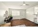 Bright and airy living area with hardwood floors, a ceiling fan, and a modern desk area perfect for work from home at 1513 S Rural St, Indianapolis, IN 46203