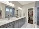 Modern bathroom features double sinks, spacious countertops, and glass shower with tiled walls at 1586 Mairn Ave, Carmel, IN 46032