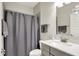 Bathroom showcasing modern vanity with sleek gray cabinetry and coordinated gray shower curtain at 1586 Mairn Ave, Carmel, IN 46032