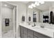 Bathroom featuring a double vanity, well-lit mirror, and tile flooring at 1586 Mairn Ave, Carmel, IN 46032