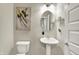 Powder room featuring a pedestal sink, elongated toilet and modern art at 1586 Mairn Ave, Carmel, IN 46032