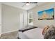 Well-lit bedroom features a ceiling fan, ample natural light, and plush carpeting at 1586 Mairn Ave, Carmel, IN 46032
