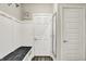 Bright entryway features white trim, hooks, bench, decor, and a door with a five-panel design at 1586 Mairn Ave, Carmel, IN 46032