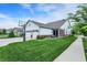 Side view of a two-story home with a well-manicured lawn, three-car garage and a basketball hoop at 1586 Mairn Ave, Carmel, IN 46032
