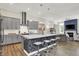 Open concept kitchen with stainless steel appliances, quartz countertops, and a large island with bar seating at 1586 Mairn Ave, Carmel, IN 46032