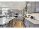 Spacious kitchen with stainless steel appliances, grey cabinets, and plenty of counter space at 1586 Mairn Ave, Carmel, IN 46032