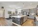 Modern kitchen featuring gray cabinets, stainless steel appliances, and a spacious island at 1586 Mairn Ave, Carmel, IN 46032