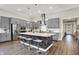 Well-equipped kitchen with modern appliances, a large island with seating, and stylish pendant lighting at 1586 Mairn Ave, Carmel, IN 46032