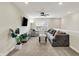 Carpeted living room with gray furniture, large window, fan and wall-mounted television at 1586 Mairn Ave, Carmel, IN 46032