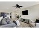 Modern living room with gray sofas, carpet, ceiling fan and wall-mounted television at 1586 Mairn Ave, Carmel, IN 46032
