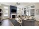 Spacious living room with fireplace, large windows, and modern furnishings with a ceiling fan at 1586 Mairn Ave, Carmel, IN 46032
