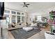 Open-concept living room with abundant natural light and direct view to the kitchen and dining area at 1586 Mairn Ave, Carmel, IN 46032