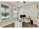 Well-lit home office with a built-in bookcase, a ceiling fan, and two large windows at 1586 Mairn Ave, Carmel, IN 46032