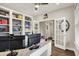 Spacious home office featuring built-in shelves, double doors, and a view of the hallway at 1586 Mairn Ave, Carmel, IN 46032