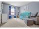 Charming Bedroom with a bright blue crib, soft gray rocking chair, and playful décor at 1605 Perry Commons Blvd, Indianapolis, IN 46217