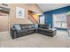 Spacious living room with a sectional sofa, neutral paint, and a staircase at 1605 Perry Commons Blvd, Indianapolis, IN 46217