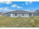 A spacious backyard view of home with a grassy lawn and neutral siding at 1612 Paula Dr, Columbus, IN 47201