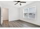 A bedroom with a large window and stylish gray wood flooring at 1612 Paula Dr, Columbus, IN 47201