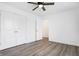 A bedroom with a ceiling fan, closet, and stylish gray wood flooring at 1612 Paula Dr, Columbus, IN 47201