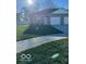 Traditional home exterior with a well-maintained lawn, attached garage, and modern design at 1612 Paula Dr, Columbus, IN 47201