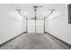 Clean, empty two car garage with concrete floor and white sectional door at 1612 Paula Dr, Columbus, IN 47201