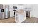 A kitchen featuring stainless steel appliances, white cabinets, and a kitchen island at 1612 Paula Dr, Columbus, IN 47201