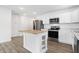 A kitchen featuring stainless steel appliances, white cabinets, and a kitchen island at 1612 Paula Dr, Columbus, IN 47201