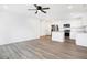 Open-concept living area with modern kitchen, stainless appliances, and white cabinets at 1612 Paula Dr, Columbus, IN 47201
