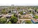 A dynamic aerial view of homes amidst green trees, creating a serene urban landscape at 1717 Carrollton Ave, Indianapolis, IN 46202