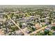 An aerial view of a neighborhood offering glimpses of community parks and tree-filled streets at 1717 Carrollton Ave, Indianapolis, IN 46202