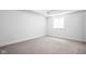This bedroom has neutral carpet and white walls, creating a calm space at 1717 Carrollton Ave, Indianapolis, IN 46202