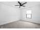 This bedroom features carpet, white walls, a window, and a modern ceiling fan at 1717 Carrollton Ave, Indianapolis, IN 46202