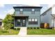 Charming two-story home with blue siding, a well-manicured lawn, and a welcoming front porch at 1717 Carrollton Ave, Indianapolis, IN 46202