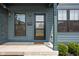 Inviting front porch with stylish front door, modern lighting fixtures, and manicured shrubbery at 1717 Carrollton Ave, Indianapolis, IN 46202