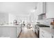 Bright, modern kitchen with white cabinets, stainless steel appliances, and an open floor plan to the living room at 1717 Carrollton Ave, Indianapolis, IN 46202
