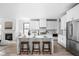 Well-lit kitchen with an island, bar stool seating, stainless steel appliances, and an open floor plan at 1717 Carrollton Ave, Indianapolis, IN 46202