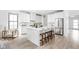 Modern kitchen with an island, bar stool seating, stainless steel appliances, and light wood floors at 1717 Carrollton Ave, Indianapolis, IN 46202