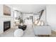Open concept living room flowing into a modern kitchen with a fireplace and comfortable seating at 1717 Carrollton Ave, Indianapolis, IN 46202