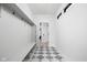 Entryway mudroom with checkerboard tile floors, bench seating, coat hooks, and natural light at 1717 Carrollton Ave, Indianapolis, IN 46202