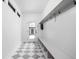 Entryway mudroom featuring checkerboard tile flooring, bench seating, and coat hooks at 1717 Carrollton Ave, Indianapolis, IN 46202