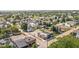 Aerial view of a mixed-use neighborhood featuring a variety of housing, commercial buildings, and mature trees at 1717 Carrollton Ave, Indianapolis, IN 46202