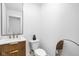 Stylish powder room featuring a decorative vanity and a modern, round mirror at 1717 Carrollton Ave, Indianapolis, IN 46202