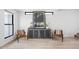 Interior view of a living space featuring chairs, a cabinet, and a window at 1717 Carrollton Ave, Indianapolis, IN 46202