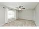 Spacious bedroom featuring soft carpet, neutral walls, a ceiling fan, and a bright window at 18005 Gasparilla Ct, Westfield, IN 46062