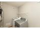 Convenient laundry room includes modern washer, dryer, and shelving for storage at 18005 Gasparilla Ct, Westfield, IN 46062