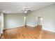 Bright living room features hardwood floors, ceiling fan and access to other living areas at 18005 Gasparilla Ct, Westfield, IN 46062