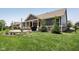 Charming backyard featuring a cozy patio, lush green grass, and mature landscaping, perfect for outdoor living at 18998 Beverly Shones Ln, Noblesville, IN 46062