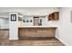 Finished basement bar features wooden accents, granite counters, and a sliding barn door at 18998 Beverly Shones Ln, Noblesville, IN 46062