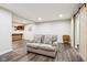 Basement seating area with wood floors, sofa, and sliding barn door at 18998 Beverly Shones Ln, Noblesville, IN 46062